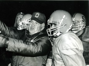 Queen’s Golden Gaels head coach Doug Hargreaves talks with some of his players during a football practice in November 1991. (Ian MacAlpine/The Whig-Standard)