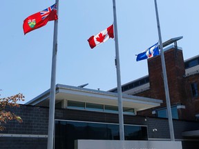 Flags were at half-mast at all Toronto Police stations to commemorate the death of two parking enforcement  officers on the job on Wednesday July 6, 2016. Michael Peake/Toronto Sun/Postmedia Network