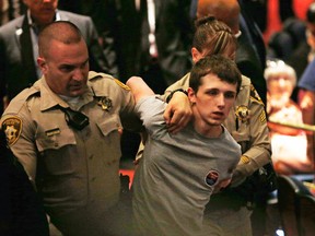 In this June 18, 2016, photo, police remove Michael Steven Sandford as Republican presidential candidate Donald Trump speaks at the Treasure Island hotel and casino in Las Vegas. Sandford, a British man accused of trying to take a police officer's gun and kill Donald Trump during a weekend rally in Las Vegas. (AP Photo/John Locher)