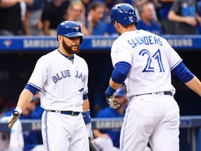 Blue Jays' Russell Martin (left) congratulates Michael Saunders on his solo home run against the Royals during fourth inning MLB action in Toronto on Wednesday, July 6, 2016. (Frank Gunn/The Canadian Press)