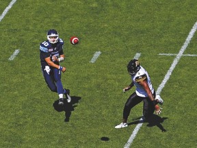 Tiger-Cats’ Adrian Tracy (5) scampers after Argos QB Logan Kilgore during a pre-season game last month. (Jack Boland, Toronto Sun)