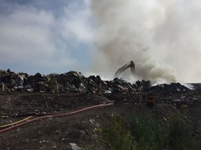 London firefighters battle a blaze Thursday morning at the municipal landfill site on Manning Drive in South London. The fire was brought under control quickly, but smoke from the fire contributed to a haze hanging over south London much of the morning. (DEBORA VAN BRENK, The London Free Press)