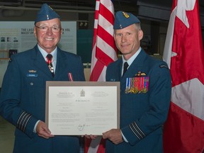 8 Wing Imaging photo
Newly invested Honorary-Colonel Glenn Rainbird accepts his appointment certificate from Lieutenant-Colonel Bill Church, Commanding Officer 429 Transport Squadron during a ceremony held this morning at the National Air Force Museum of Canada.