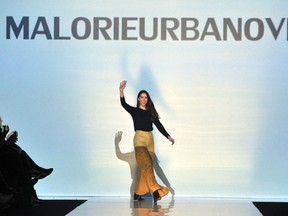 Designer Malorie Urbanovitch greets the audience at the close of the Malorie Urbanovitch show at Toronto Fashion Week in Toronto, Tuesday, March 15, 2016. (THE CANADIAN PRESS/Galit Rodan)