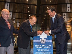 The Toronto Maple Leafs President and Alternate Governor Brendan Shanahan, right,and the Toronto Maple Leafs alumni Johnny Bower, centre, and Ron Ellis unveil the club’s Centennial Anniversary logo as the Hockey Hall of Fame opens a special exhibit commemorating the team’s 100th year in Thursday July 7, 2016. THE CANADIAN PRESS/Eduardo Lima.