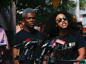 Co-founders of Black Lives Matter - Alexandria Williams (R) and Rodney Diverlus -speak at the mic during press conference to talk about the mayor, police and PRIDE and what happened on the weekend and their demands as an organization on Thursday July 7, 2016. Jack Boland/Toronto Sun/Postmedia Network
