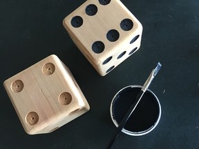 To make your own extra set of giant dice, drill dimples, apply coating and paint.