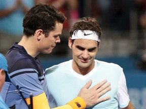 Milos Raonic (left) speaks to Roger Federer after winning the Brisbane International tennis tournament in Brisbane, Australia, on Jan. 10, 2016. Raonic faces Federer in a Wimbledon semifinal on Friday, July 8. (Tertius Pickard/AP Photo)