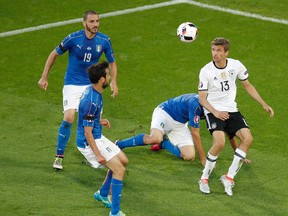 Germany's Thomas Mueller (right) vies for the ball with Italy's Leonardo Bonucci (left) and Marco Parolo during the Euro 2016 quarterfinal match at the Nouveau Stade in Bordeaux, France, on Saturday, July 2, 2016. (Michael Sohn/AP Photo)