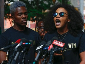 Co-founders of Black Lives Matter Alexandria Williams, right, and Rodney Diverlus speaks at the microphone during press conference to talk  about the mayor, police and Pride Toronto and what happened on the weekend and their demands as an organization on Thursday July 7, 2016. (Jack Boland/Toronto Sun/Postmedia Network)