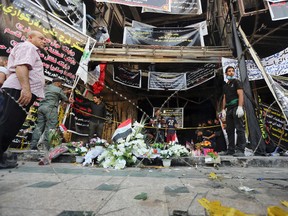 Iraqis gather at the scene of Sunday's massive truck bomb attack claimed by the Islamic State group in the Karada neighborhood, Baghdad, Iraq, Thursday, July 7, 2016. (AP Photo/Khalid Mohammed)