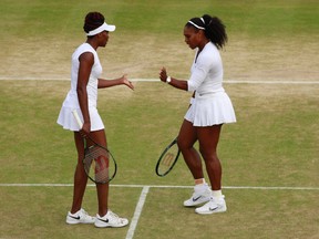Serena and Venus Williams of The United States in conversation during the Ladies Doubles Quarter Finals match against Ekaterina Makarova of Russia and Elena Vesnina of Russia on day ten of the Wimbledon Lawn Tennis Championships.  (Photo by Adam Pretty/Getty Images)
