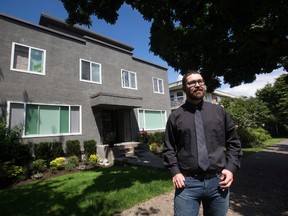 Iain Marjoribanks, a university student researcher who has determined that more than half of recent Vancouver Airbnb listings were being run by commercial hosts, stands for a photograph in front of a 29-unit apartment building that reportedly has 17 Airbnb listings, in Vancouver, B.C., on Wednesday July 6, 2016. THE CANADIAN PRESS/Darryl Dyck