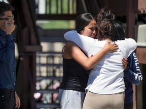 Family and friends gather at a memorial for Abril and Jose Izazaga set up at the Millcreek Apartments in Midvale, Utah on Thursday, July 7, 2016. Siblings Abril and Jose Izazaga were shot and killed Wednesday night. (Spenser Heaps/The Deseret News via AP)