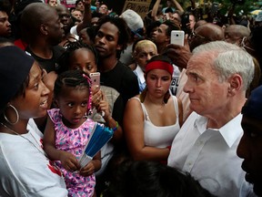Minnesota Gov. Mark Dayton, right, meets with people, including Diamond Reynolds, left, and her daughter, at the Governor's Mansion in St. Paul, Minn., as protesters gathered to decry the shooting death of Reynolds' boyfriend, Philando Castile, by police in Falcon Heights, Minn. (Richard Tsong/Star Tribune via AP)