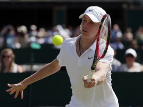 Denis Shapovalov of Canada plays a return to Yunseong Chung of Korea during their boy's singles match on day ten of the Wimbledon Tennis Championships in London, Wednesday, July 6, 2016. (AP Photo/Tim Ireland)