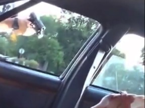 This still image taken from video by Diamond Reynolds shows a police officer pointing a gun at her boyfriend, Philando Castile, during a traffic stop on Wednesday, July 6, 2016 in Falcon Heights, Minn. The officer shot Castile, and Reynolds apparently livestreamed the aftermath on Facebook from the passenger seat. As the video and word of the shooting spread, scores of people gathered at the scene and outside the hospital where Castile died. (Diamond Reynolds via AP)
