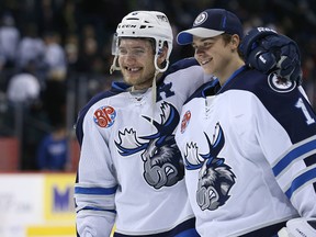 Brenden Kichton (left) and goaltender Eric Comrie pose for a picture after beating the Rockford Icehogs during its final home game of the AHL season at MTS Centre this past April. Kichton signed a one-year deal with the Winnipeg Jets on Friday. (Kevin King/Winnipeg Sun file photo)