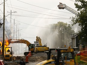 Intelligencer file photo
Belleville firefighters use an aerial ladder to pour water on a natural-gas fire in Belleville in October. The fall explosion has resulted in charges being laid against a supervisor.
