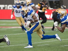 Winnipeg Blue Bombers defensive back Maurice Leggett (31) heads for the end zone for a touchdown following an interception against the Hamilton Tiger-Cats on Thursday night. (THE CANADIAN PRESS/Peter Power)