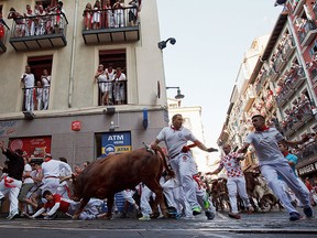 Revellers run with Cebada Gago's fighting bulls entering Estafeta St. during the third day of the San Fermin Running of the Bulls festival on July 8, 2016 in Pamplona, Spain.  (Photo by Pablo Blazquez Dominguez/Getty Images)