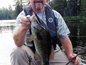 Columnist Frank Clark shows off a smallmouth bass he caught while pre-fishing on Onaping Lake a few weeks ago. Bruce Heidman/The Sudbury Star/Postmedia Network