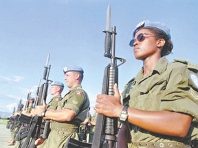 Canadian peacekeepers prepare for a parade at Maple Leaf Camp in Port-au-Prince, Haiti on Nov. 28, 1997. The Trudeau government has promised to get Canada back into the peacekeeping business, but former Liberal cabinet minister Alan Rock wants to see major improvements to the UN?s accountability for the blue berets. (Canadian Press file photo)