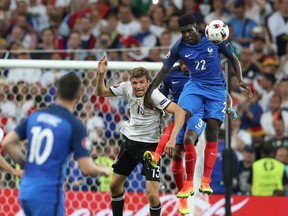 France's Samuel Umtiti (right) jumps for a header with Germany's Thomas Mueller during their Euro 2016 semifinal match in Marseille, France, on Thursday, July 7, 2016. (Thanassis Stavrakis/AP Photo)