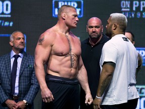 Brock Lesnar (left) looks at Mark Hunt during the UFC 200 weigh-ins in Las Vegas on Friday, July 8, 2016. (L.E. Baskow/Las Vegas Sun via AP)