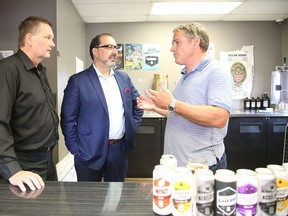 Walter Siggelkow, president of Hard-Line, MPP Glenn Thibeault and Shawn Mailloux, owner of Stack Brewing, chat following a press conference announcing more than $1 million in provincial funding to three Sudbury companies, including Stack, on Friday. (Gino Donato/Sudbury Star)