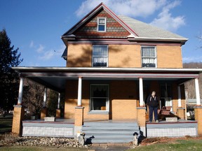 In this Jan. 11, 2016 file photo, Scott Lloyd stands on the front porch of his home which is the house used as the home of psychotic killer Buffalo Bill in the 1991 film "The Silence of the Lambs" in Perryopolis, Pa.  (AP Photo/Keith Srakocic)