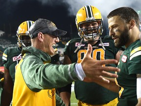 Edmonton Eskimos head coach Jason Maas about to embrace quarterback Mike Reilly (13) after defeating the Saskatchewan Roughriders in overtime during CFL action at Commonwealth Stadium in Edmonton, Friday, July 8, 2016. Ed Kaiser/Postmedia (For Edmonton Journal story by Dan Barnes)