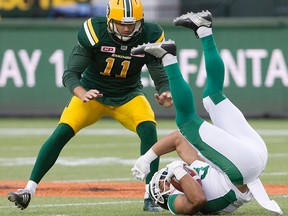 Saskatchewan Roughriders' Nic Demski (9) is upended as Edmonton Eskimos' Grant Shaw (11) looks for the tackle during first half action in Edmonton, Alta., on Friday July 8, 2016. THE CANADIAN PRESS/Jason Franson. ORG XMIT: EDM130