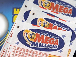 In this July 1, 2016, file photo, Mega Millions lottery tickets rest on a counter at a Pilot travel center near Burlington, N.C.  (AP Photo/Gerry Broome, File)