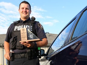 Constable Jarrett Rutledge of the Stirling-Rawdon Police Service (SRPS) displays the Ontario Association of Chiefs of Police’s (OACP) School Resource Officer Award of Excellence he received for his work with youth in the community on Friday July 8, 2016 in Stirling, Ont. Tim Miller/Belleville Intelligencer/Postmedia Network