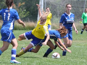 Cambridge United's Sophie Rebelo blocks Kingston Clippers Mackenzie Poole during the Ambassador Cup 2016- U18 division action at Caton's Field in Kingston, Ont. on Saturday July 9, 2016. Cambridge defeated the Clippers 2-1. Steph Crosier/Kingston Whig-Standard/Postmedia Network