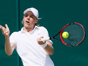 Denis Shapovalov returns to Mate Valkusz during their singles match at Wimbledon in London, Thursday, July 7, 2016. (AP Photo/Kirsty Wigglesworth)