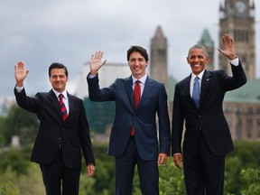 From left to right: Mexican President Enrique Pena Nieto, Canadian Prime Minister Justin Trudeau and U.S. President Barack Obama pose for a group photo with Canada's Parliament Hill in the background during the North American Leaders Summit on June 29, 2016 in Ottawa. (AFP PHOTO/Chris RoussakisCHRIS ROUSSAKIS/AFP/Getty Images)