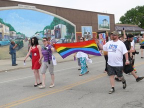 Steinbach Pride organizers (left to right) Michelle McHale, Karen Phillips and Chris Plett hold the rainbow banner in leading the first-ever Steinbach Pride march, Saturday, July 9, 2016 in Steinbach. Between 4,000 to 5,000 marchers took part in the march. (GLEN DAWKINS/WINNIPEG SUN/POSTMEDIA NETWORK)
