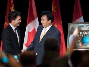 Prime Minister Justin Trudeau shakes hands with China's Ambassador to Canada Luo Zhaohui (right) after being presented a photo of his father, former Prime Minister Pierre Elliot Trudeau, meeting Chairman Mao Zedong, during a celebration of 45 years of Canada-China diplomatic relations, in Ottawa on Wednesday, Jan. 27, 2016. THE CANADIAN PRESS/Justin Tang
