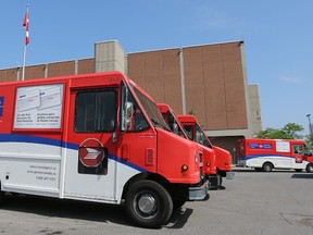 Canada Post trucks are pictured in Ottawa on July 7, 2016. (Tony Caldwell/Postmedia Network)