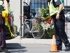A cyclist died of his injuries after hitting the rear end of a parked vehicle in Toronto on July 5, 2016. Police are searching for witnesses and are investigating whether another vehicle was involved. (Stan Behal/Toronto Sun/Postmedia Network)