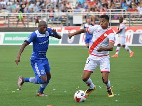 FC Edmonton's Sainey Nyassi challenges Rayo OKC defender Moises Hernandez for the ball in North American Soccer League play in Oklahoma City on July 2, 2016. The teams tied 1-1.