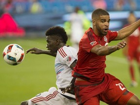 Chicago Fire midfielder Khaly Thiam, left, battles Toronto FC forward Jordan Hamilton during second half MLS soccer action, in Toronto on Saturday, July 9, 2016. THE CANADIAN PRESS/Chris Young