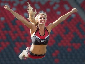 Redblacks cheerleader Brittany flies through the air during practice.