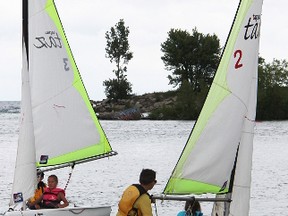 Aiden Keating and Paige Vanhoorn, left boat, chase Zachary Leaver and Sydney Vanhoorn in the Taz class mini-regatta for race-sailing novices at Sailfest Sarnia Saturday. This year Sailfest drew 85 boats, including eight in the Taz class. Tyler Kula/Sarnia Observer/Postmedia Network