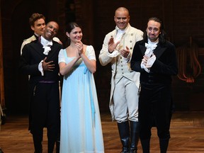 Actors Leslie Odom Jr., foreground from left, Phillipa Soo, and Christopher Jackson look on as actor and "Hamilton" creator Lin-Manuel Miranda, right, makes his final performance curtain call at the Richard Rogers Theatre on Saturday, July 9, 2016, in New York. (Photo by Evan Agostini/Invision/AP)