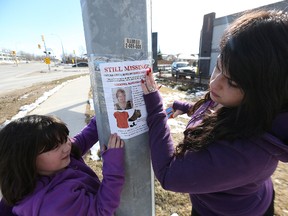 Connie Muscat and her then-seven-year-old daughter Victoria Russell put up posters for missing woman Thelma Krull near the Tim Horton's on Plessis Road in Transcona on March 19, 2016. Muscat is a friend and co-worker of the 57-year-old who went missing in July. (Kevin King/Winnipeg Sun/Postmedia Network)