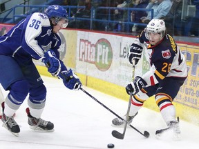GINO DONATO/THE SUDBURY STAR?QMI AGENCY
        Sudbury Wolves defenceman Conor Cummins tries to swipe the puck from Barrie Colts Andrew Mangiapane during first period OHL action from the Sudbury Community Arena on January 28/2015. Cummins will be one of three overage defenceman most likely battling for two available spots when training camp comes around in September.