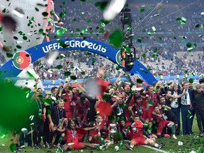 Portugal players celebrate after winning the Euro 2016 final soccer match between Portugal and France at the Stade de France in Saint-Denis, north of Paris, Sunday, July 10, 2016. Portugal won 1-0. (AP Photo/Martin Meissner)